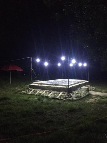a basketball court at night with lights at Mera Hostel in P'arts'khanaqanevi