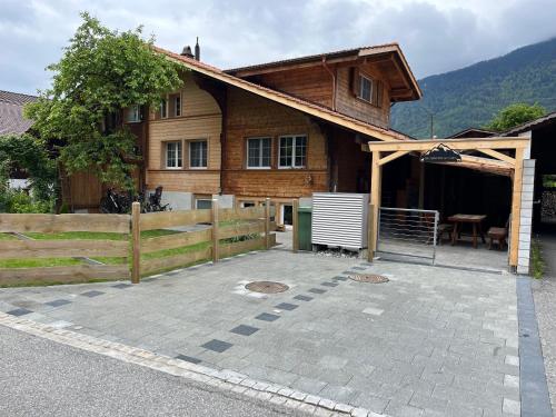 a wooden house with a patio in front of it at Mountain Homes in Bönigen