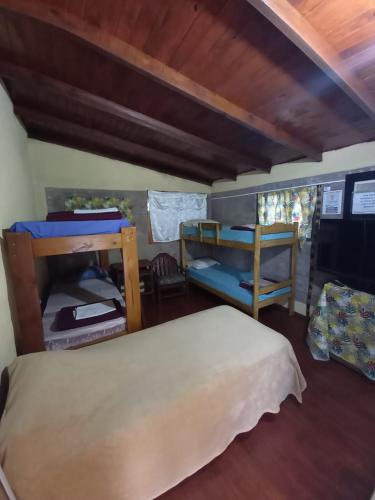 a room with a bed and a bunk bed at Hospedar in Puerto Rico