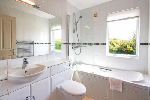 a white bathroom with a sink and a toilet at The Landings 11, Water View - P in South Cerney