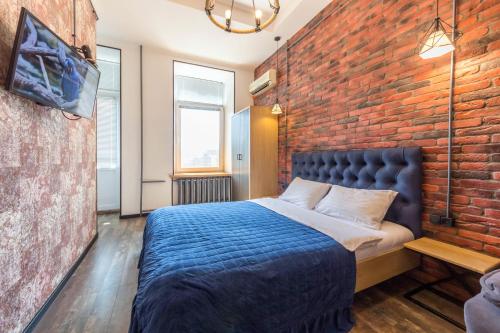 a bedroom with a brick wall and a bed at Central Dayflat Apartments in Kyiv