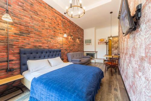 a bedroom with a brick wall and a bed at Central Dayflat Apartments in Kyiv