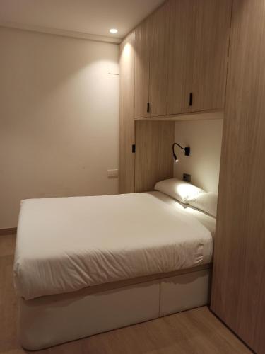 Кровать или кровати в номере Apartamentos 19 Living