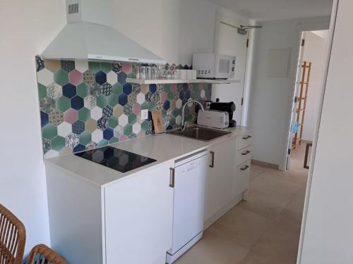 a kitchen with a sink and a counter top at Bamblue Boutique Apartments in Pineda de Mar