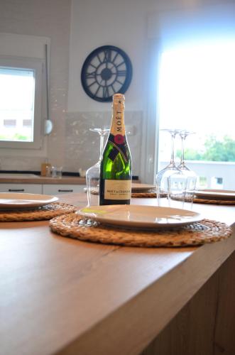eine Flasche Wein auf dem Tisch mit zwei Gläsern in der Unterkunft KooKai - Luxury Living in Peraia
