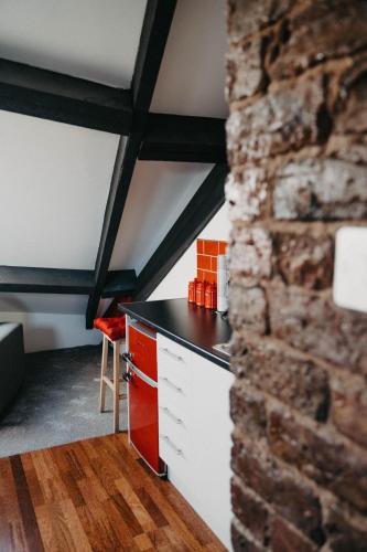 a kitchen with a counter and a brick wall at Flat Iron Anfield in Liverpool