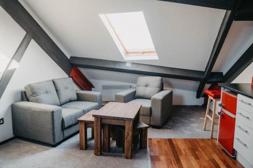 a living room with two chairs and a table at Flat Iron Anfield in Liverpool