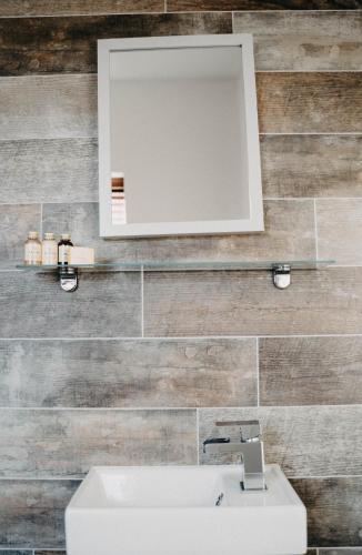 a bathroom with a sink and a mirror on a wall at Flat Iron Anfield in Liverpool