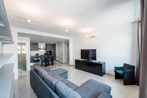 a living room with a couch and a kitchen at P&P Luxury Apartment in Bergamo