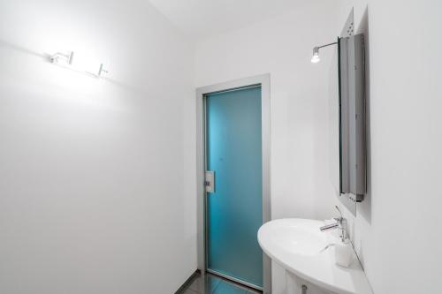 a bathroom with a glass shower and a sink at P&P Luxury Apartment in Bergamo