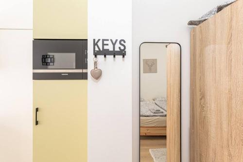 a room with a mirror and a bedroom with a bed at Beautiful studio in Antwerp
