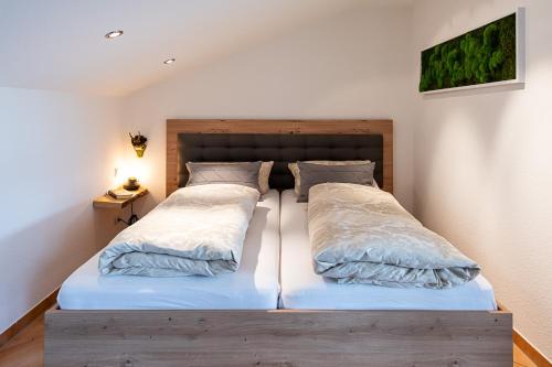 1 Schlafzimmer mit 2 Betten und einem Kopfteil aus Holz in der Unterkunft Schwarzwaldhimmel in Feldberg