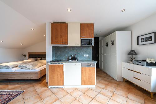 a room with a kitchen and a bedroom with a bed at Schwarzwaldhimmel in Feldberg