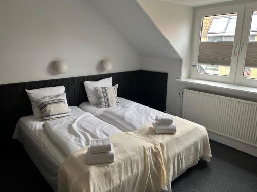 two beds sitting next to each other in a bedroom at Hotel Frederikshavn in Frederikshavn