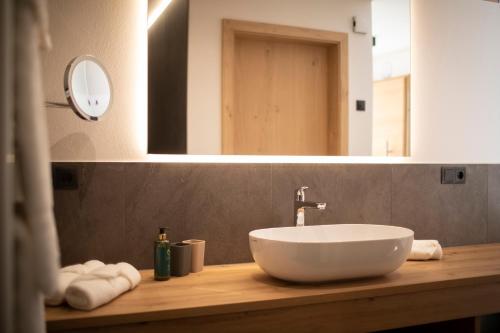 a bathroom with a white sink and a mirror at Natur Residence Kaiser Hans in Schenna