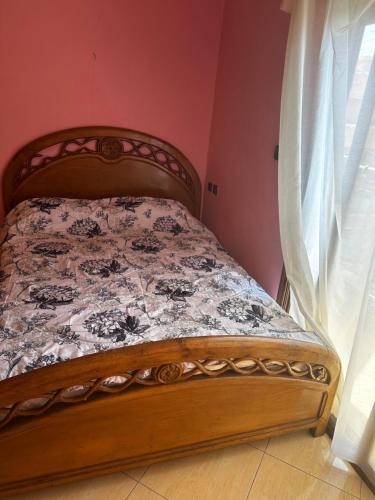 a bed sitting in a room with a window at Residence Ohod in Berrechid