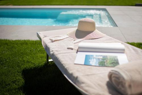 a table with a hat and a book on it at Natur Residence Kaiser Hans in Schenna