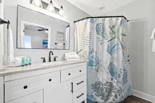 a bathroom with a sink and a shower curtain at Tidewater Beach Resort #614 by Book That Condo in Panama City Beach