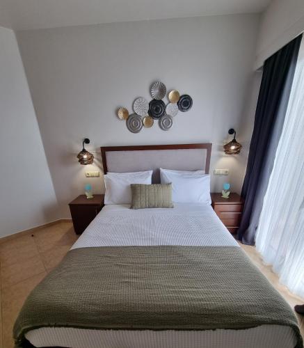 Ένα ή περισσότερα κρεβάτια σε δωμάτιο στο GreenHill Holiday Suites