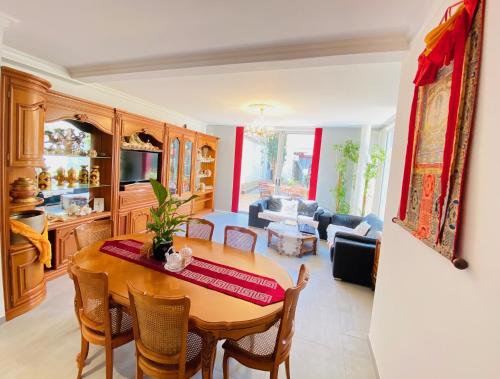 a kitchen and living room with a table and chairs at Reims Sherpa Guest House in Reims