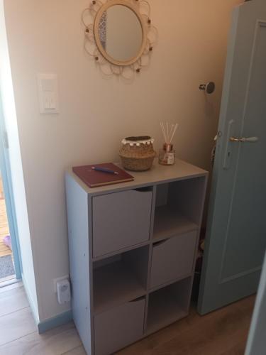 a dressing table with a mirror on a wall at Appartement a la campagne in Grièges