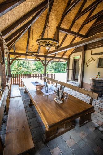 a large wooden table in a room with a ceiling at Apartmani Lara Modruš-Kuća za odmor in Modruš