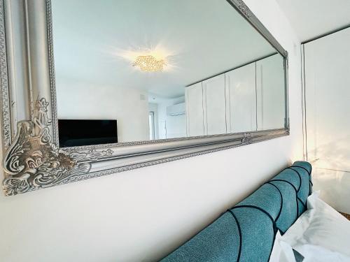 um espelho pendurado numa parede ao lado de um sofá em VILLA GIANNI - room VENEZIA - 4 stars em Lovran