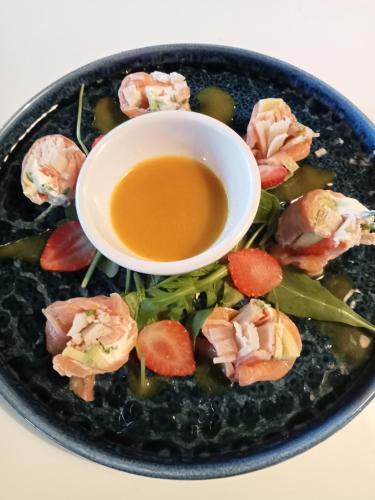 a plate of sushi with a bowl of dipping sauce at Mediterrâneo Madeira in São Vicente