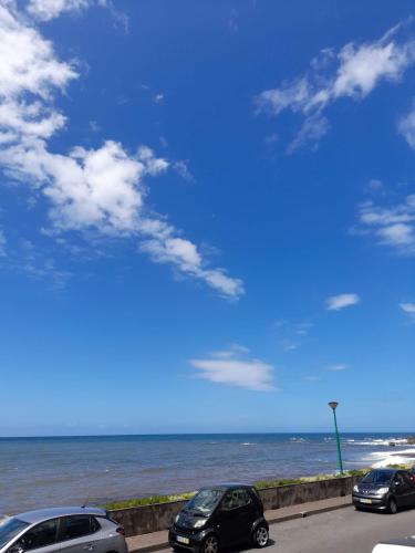 a group of cars parked next to the ocean at Mediterrâneo Madeira in São Vicente