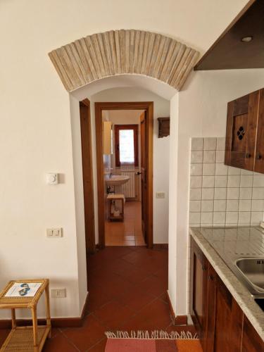 a kitchen with a hallway leading to a dining room at ABBAZIA DI VALLINGEGNO in Gubbio