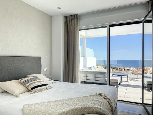 a bedroom with a bed and a view of the ocean at Via Celere 2329 Luxury apartment with Sea View in Casares