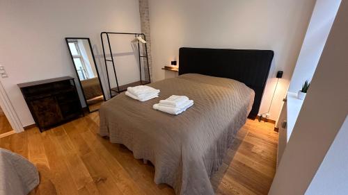a bedroom with a bed with two towels on it at Fabelagtig lejlighed R8 in Copenhagen