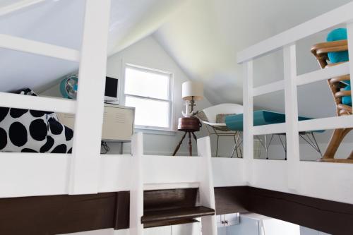 a room with a staircase with a desk and a window at Sea Lion in Nantucket