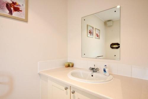 a white bathroom with a sink and a mirror at Windrush Lake 89, Lodge View - P in South Cerney