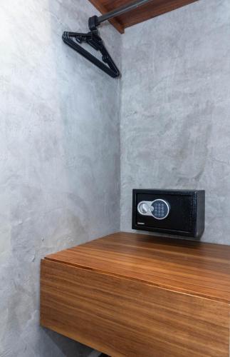 a room with a table with a television on a wall at Hotel Sun Ha Bacalar in Bacalar