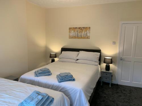 a bedroom with two beds with towels on them at Waterloo Sunset in Blackpool