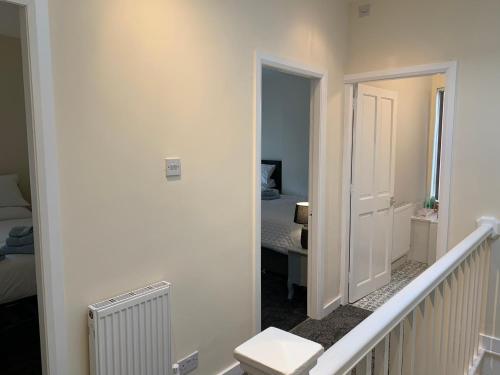 a hallway with a stairway leading to a bedroom at Waterloo Sunset in Blackpool