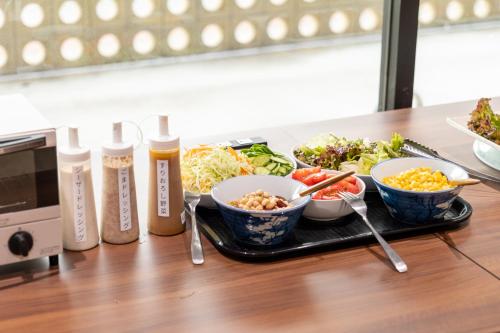a tray of food on a table with bowls of food at Hotel Sun in Takasaki