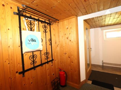 a room with a wooden wall with a sign on it at Tröger II in Imming