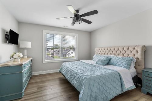 a bedroom with a bed and a ceiling fan at Lake Home Retreat w/Lake/Marina Access Golf Cart in Winchester