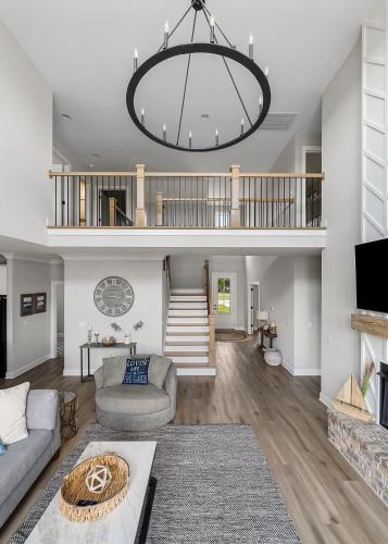 a living room with a couch and a chandelier at Lake Home Retreat w/Lake/Marina Access Golf Cart in Winchester
