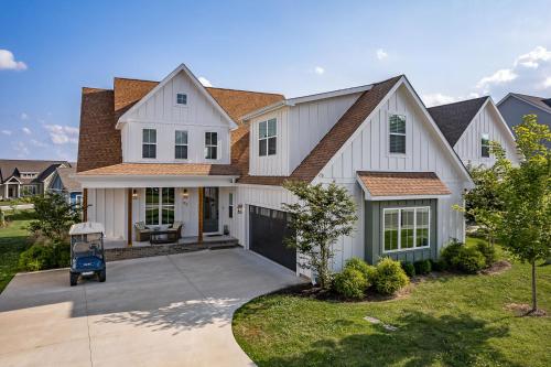 a white house with a brown roof at Lake Home Retreat w/Lake/Marina Access Golf Cart in Winchester