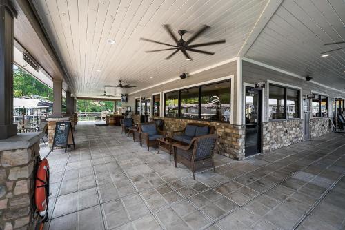 a restaurant with a ceiling fan and chairs on a patio at Lake Home Retreat w/Lake/Marina Access Golf Cart in Winchester