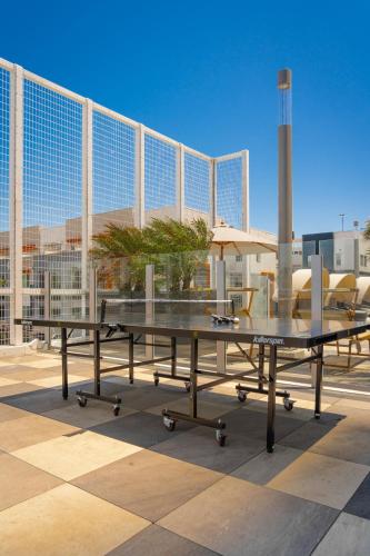 a ping pong table in front of a building at Level Long Beach - East Village in Long Beach