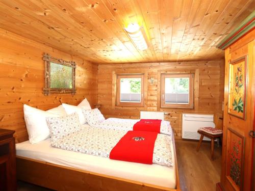 a bedroom with a bed in a wooden cabin at Tröger I in Bruck am Ziller