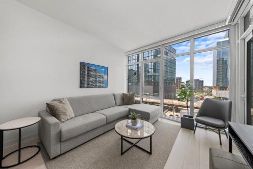 a living room with a couch and a large window at Level Chicago - Fulton Market in Chicago