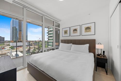 a bedroom with a large bed and a large window at Level Chicago - Fulton Market in Chicago
