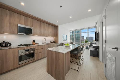 a kitchen with wooden cabinets and a counter top at Level Chicago - Fulton Market in Chicago