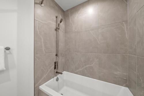 a bathroom with a white tub and a shower at Level Chicago - Fulton Market in Chicago