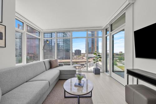 a living room with a couch and a tv at Level Chicago - Fulton Market in Chicago